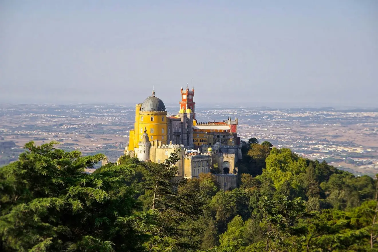 A hilltop palace above the treeline in Portugal: the D8 is filed from inside Nigeria, which is what makes it the most accessible European route for most Nigerian remote workers