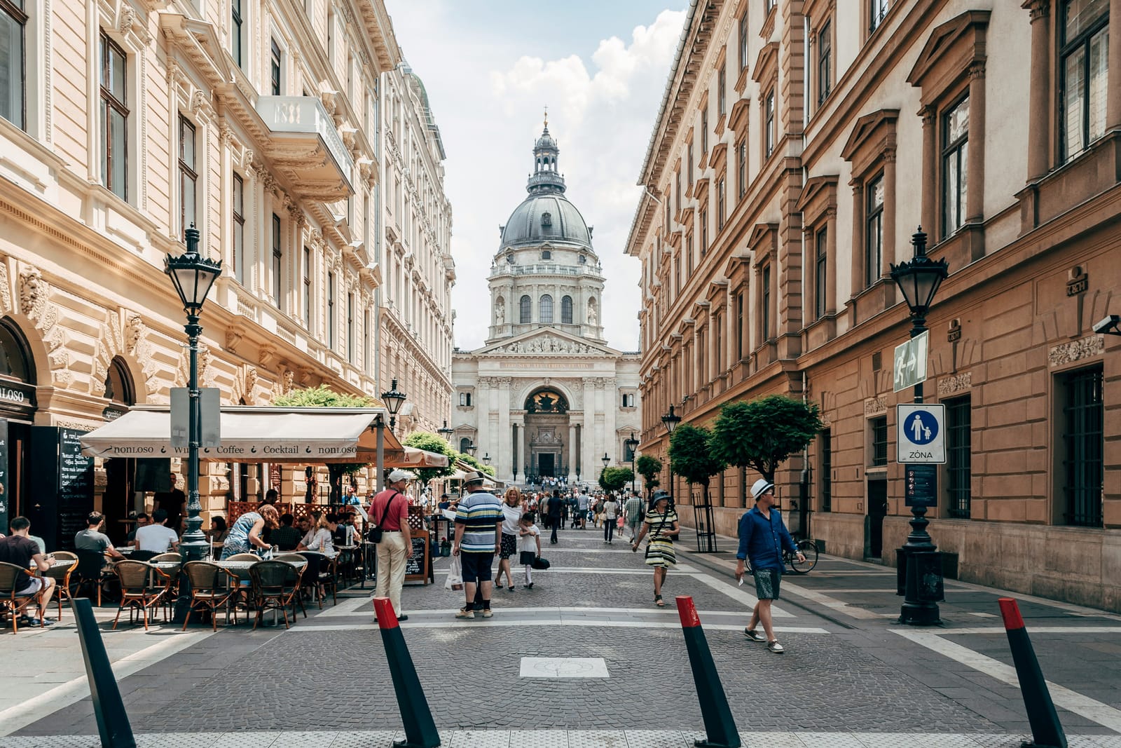 Pedestrian street with cafe terraces leading to St. Stephen's Basilica in Budapest
