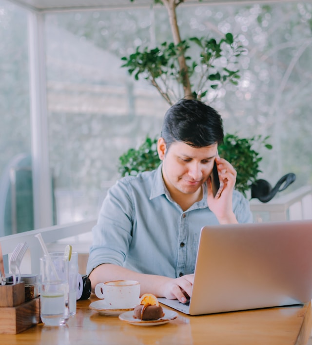 Man at table with laptop
