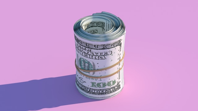 Money stack on pink