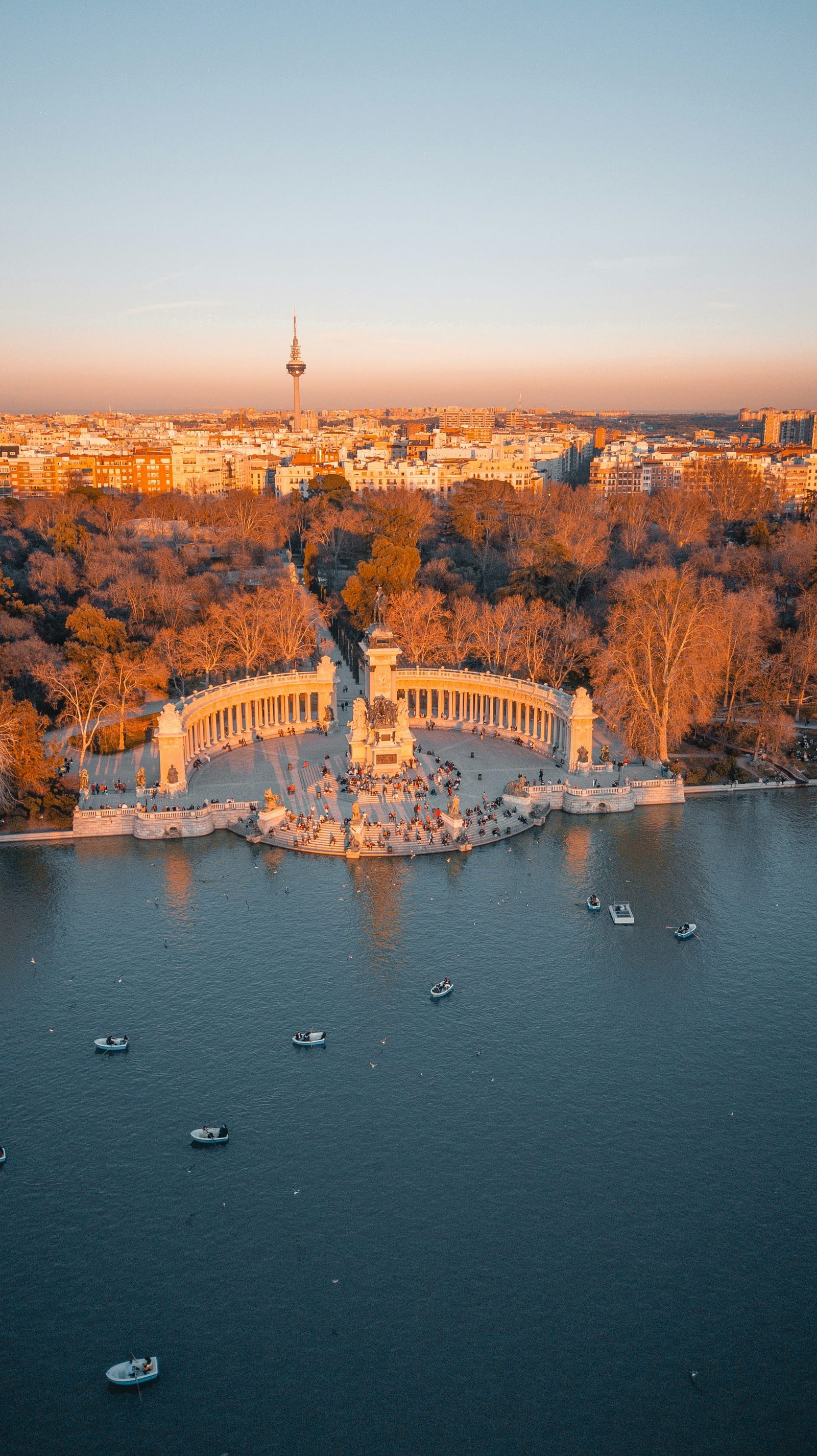 Madrid's Retiro park at dusk with the city skyline behind: Spain can tax you as resident when your main nucleus of economic interests sits there, whatever your day count